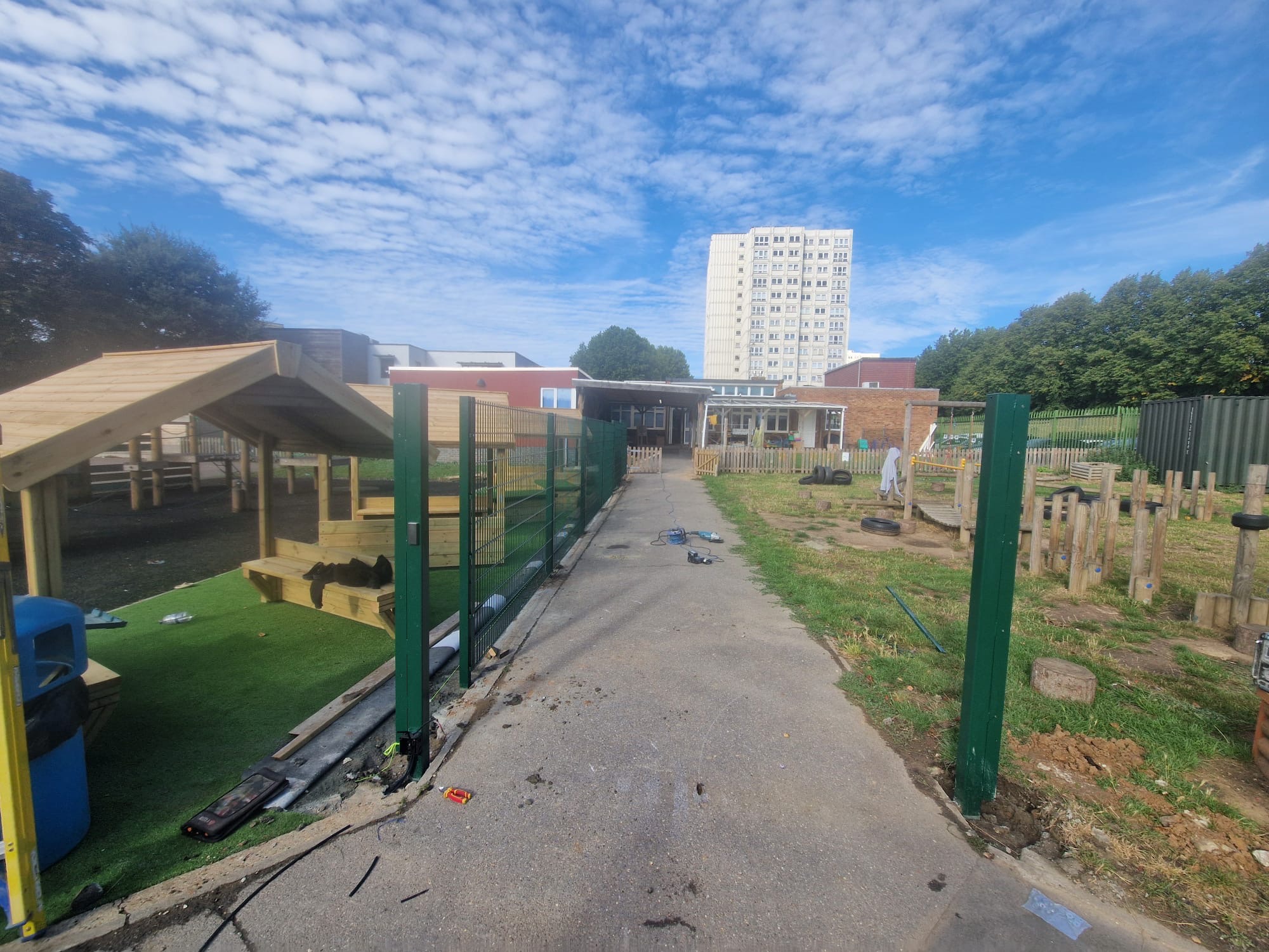 New mesh fence line and gate posts installed along the play area path