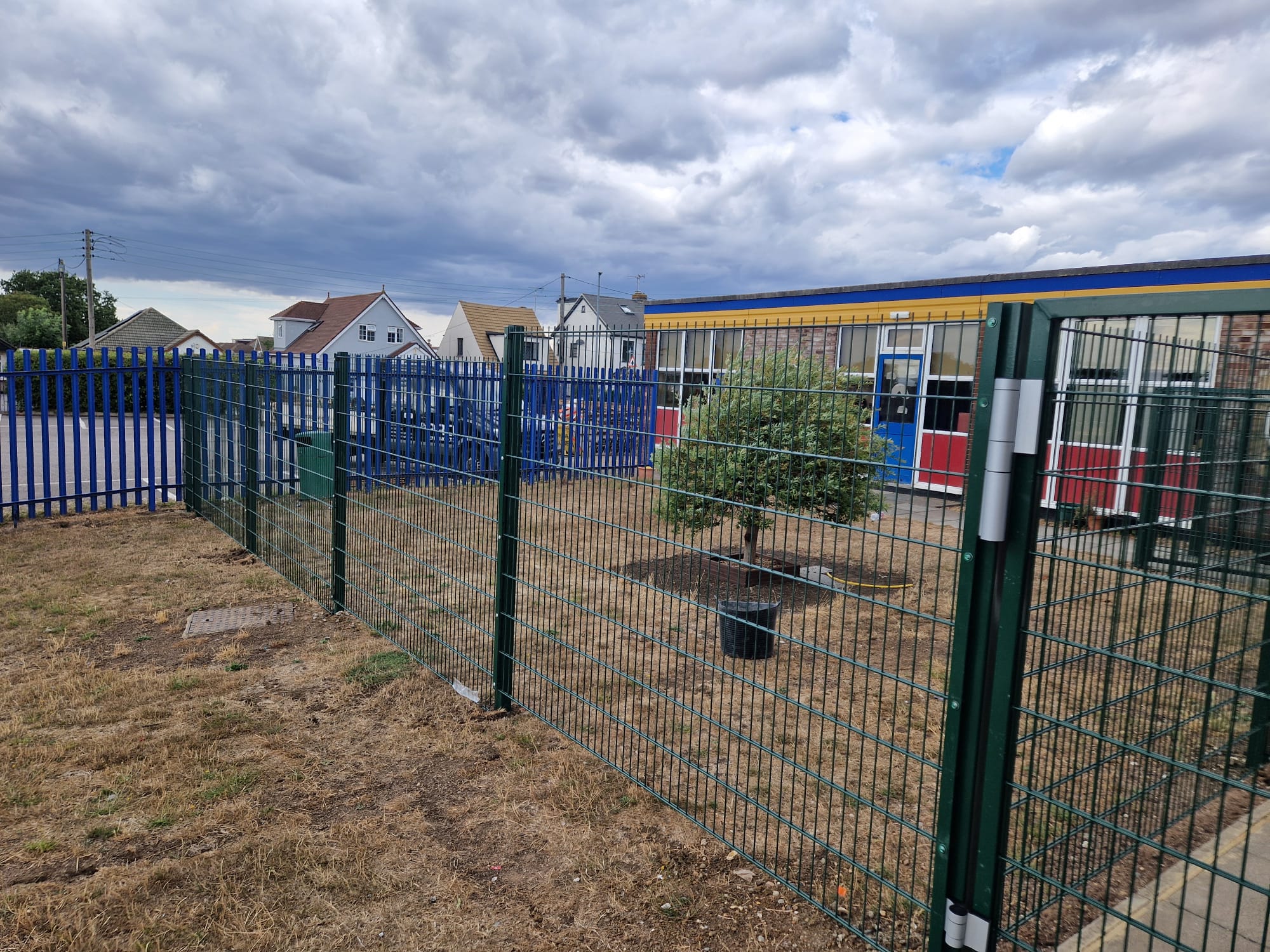 Completed green 868 twin-wire mesh gate at Holy Family Catholic Primary School