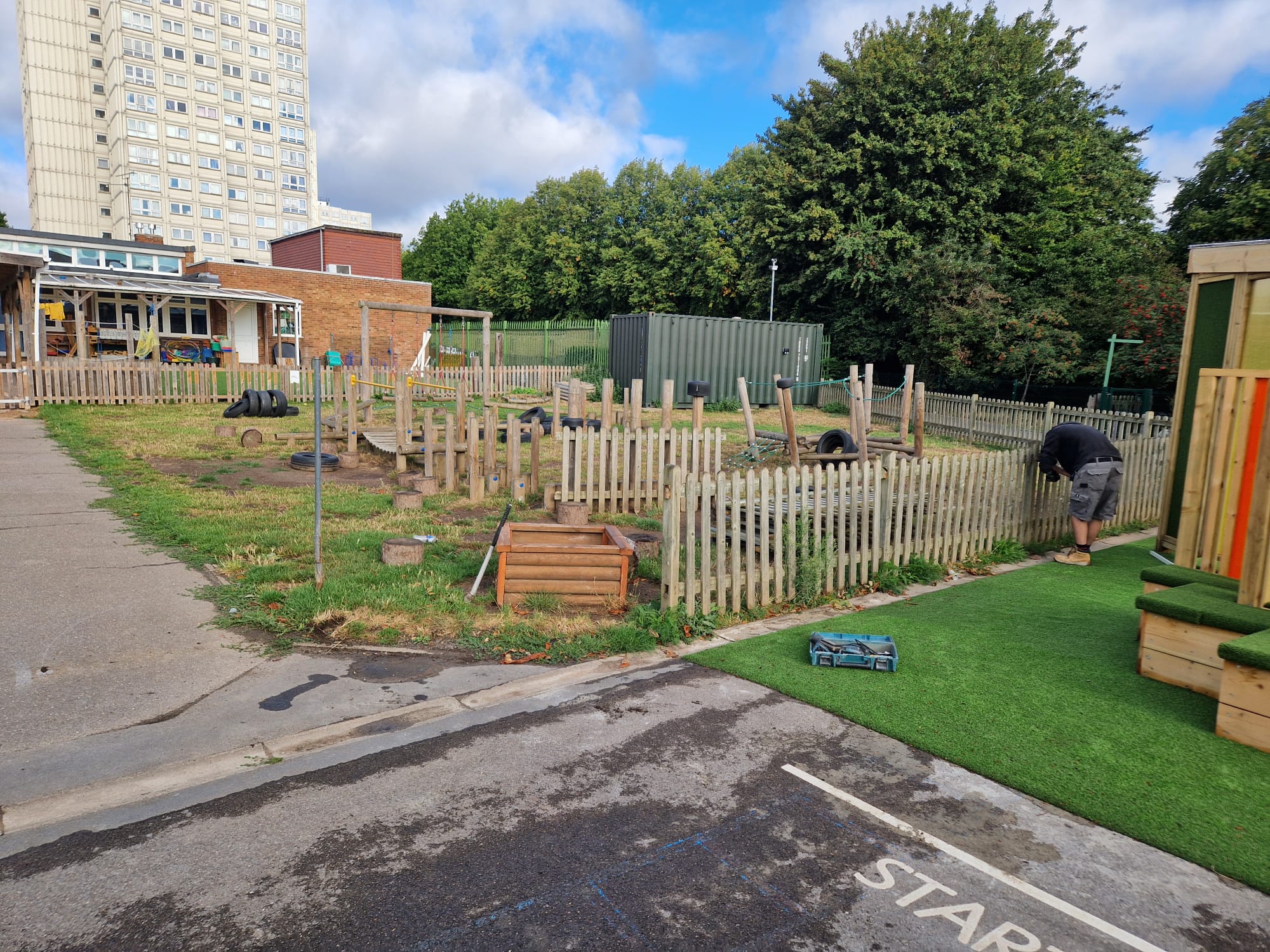Existing timber picket fencing around the school play area before works began