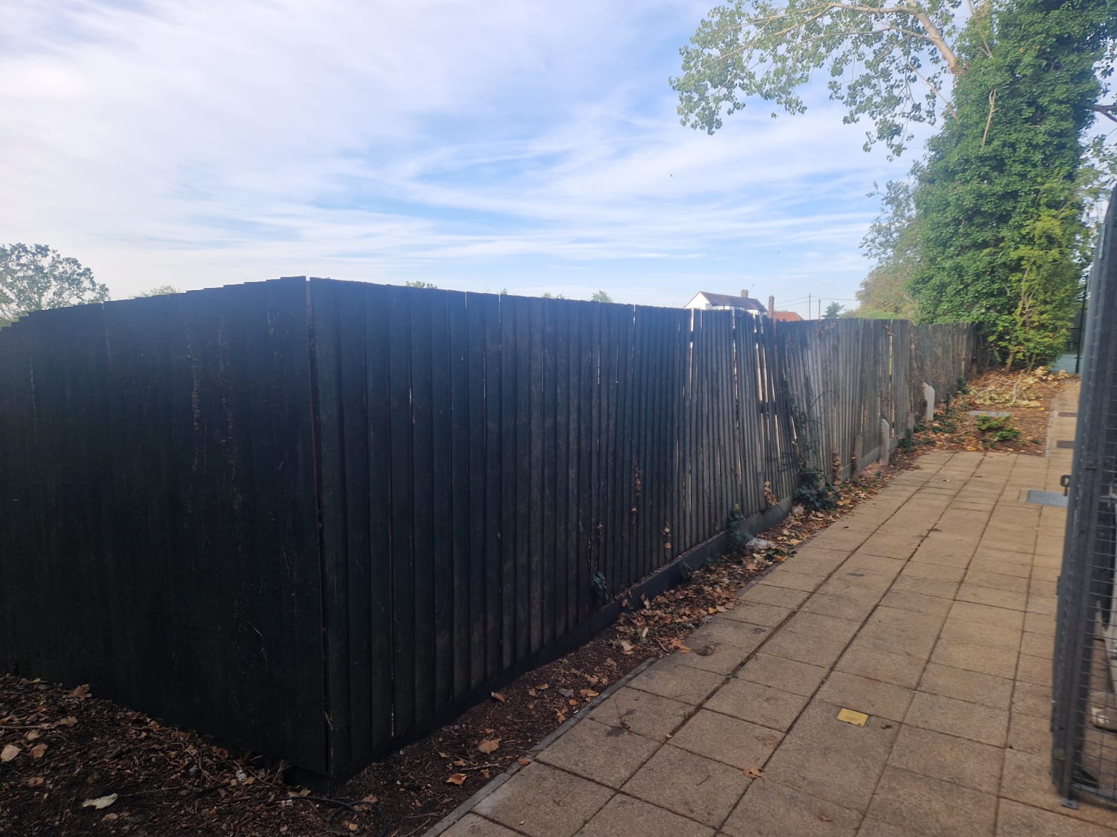Leaning timber boundary fence along the Clearview footpath before the palisade installation