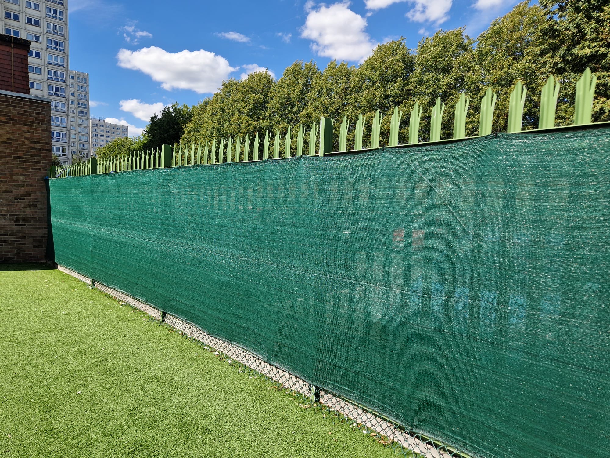 Green privacy netting fitted below the existing palisade line