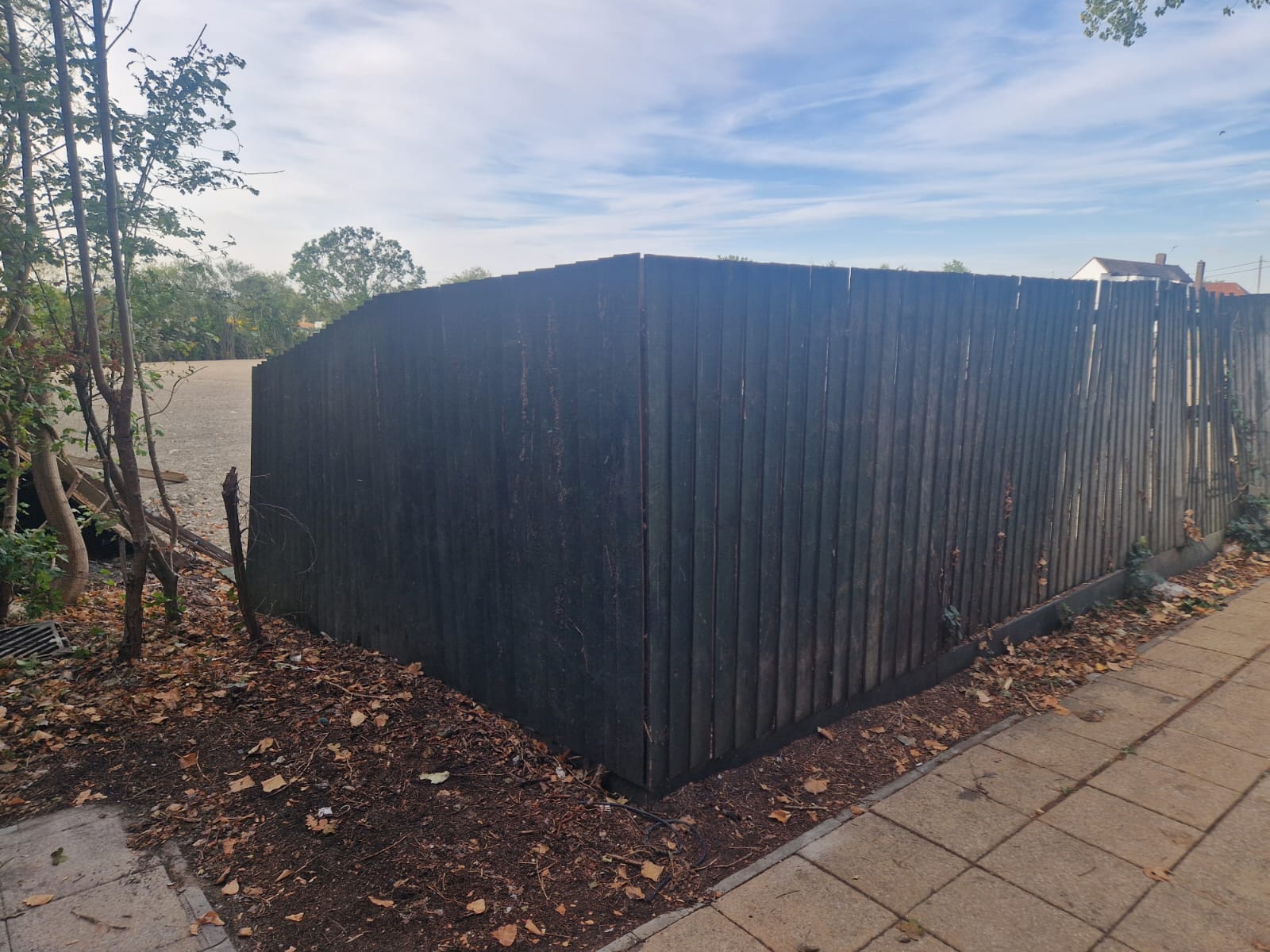 Old dark timber close-board fencing at the corner of the Clearview boundary before replacement
