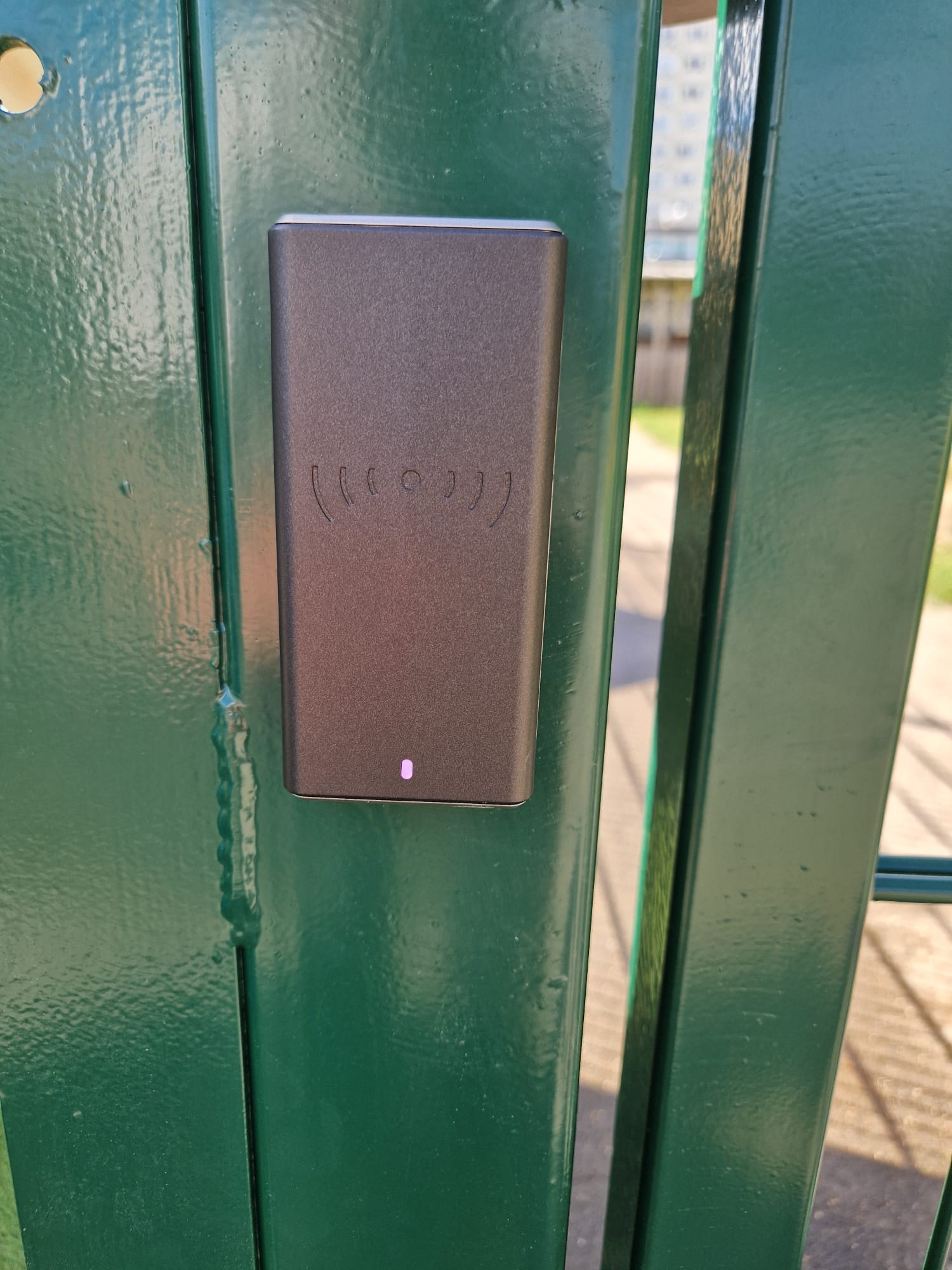 Card entry reader mounted to the mesh gate post