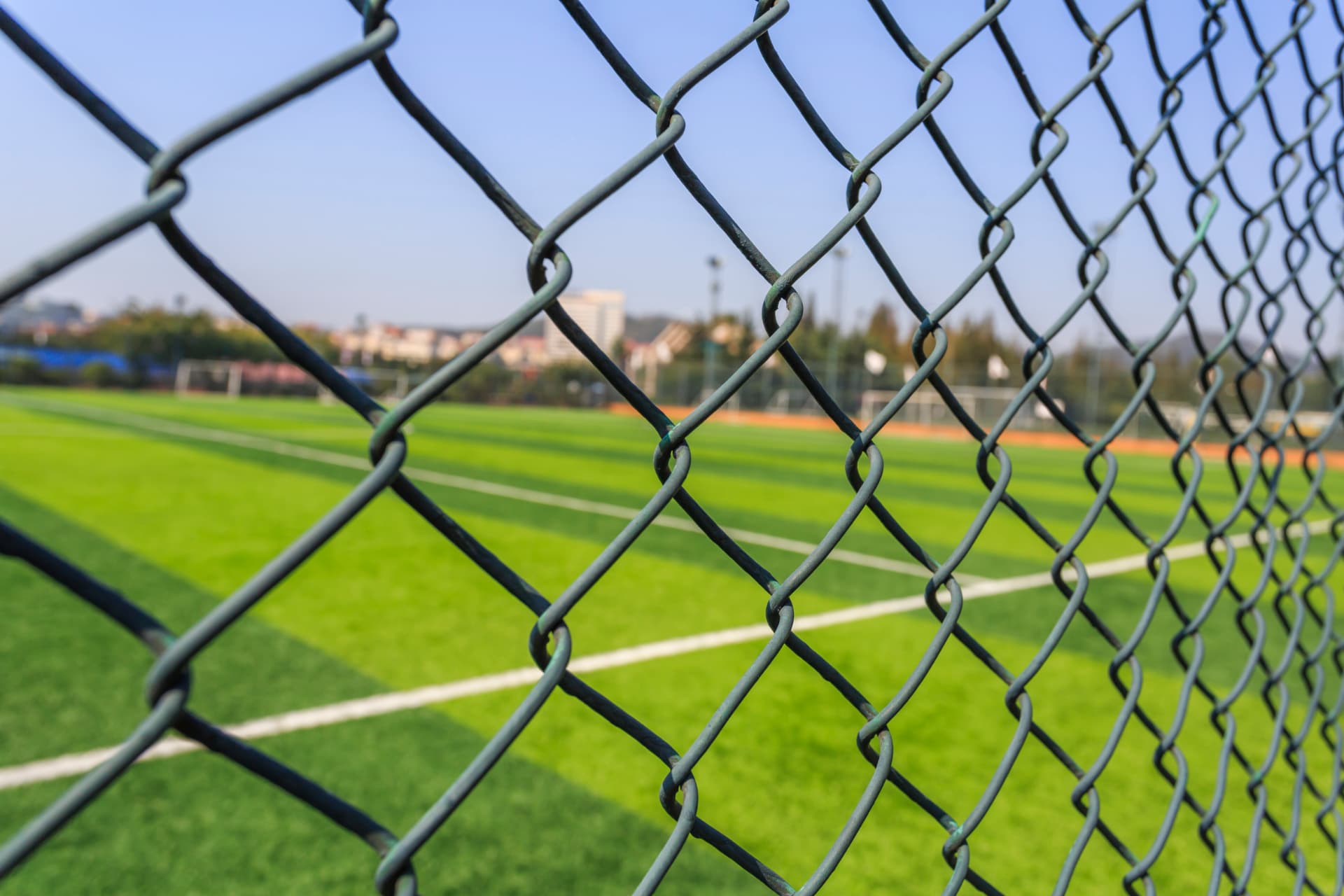 Chain link fencing in front of a sports pitch