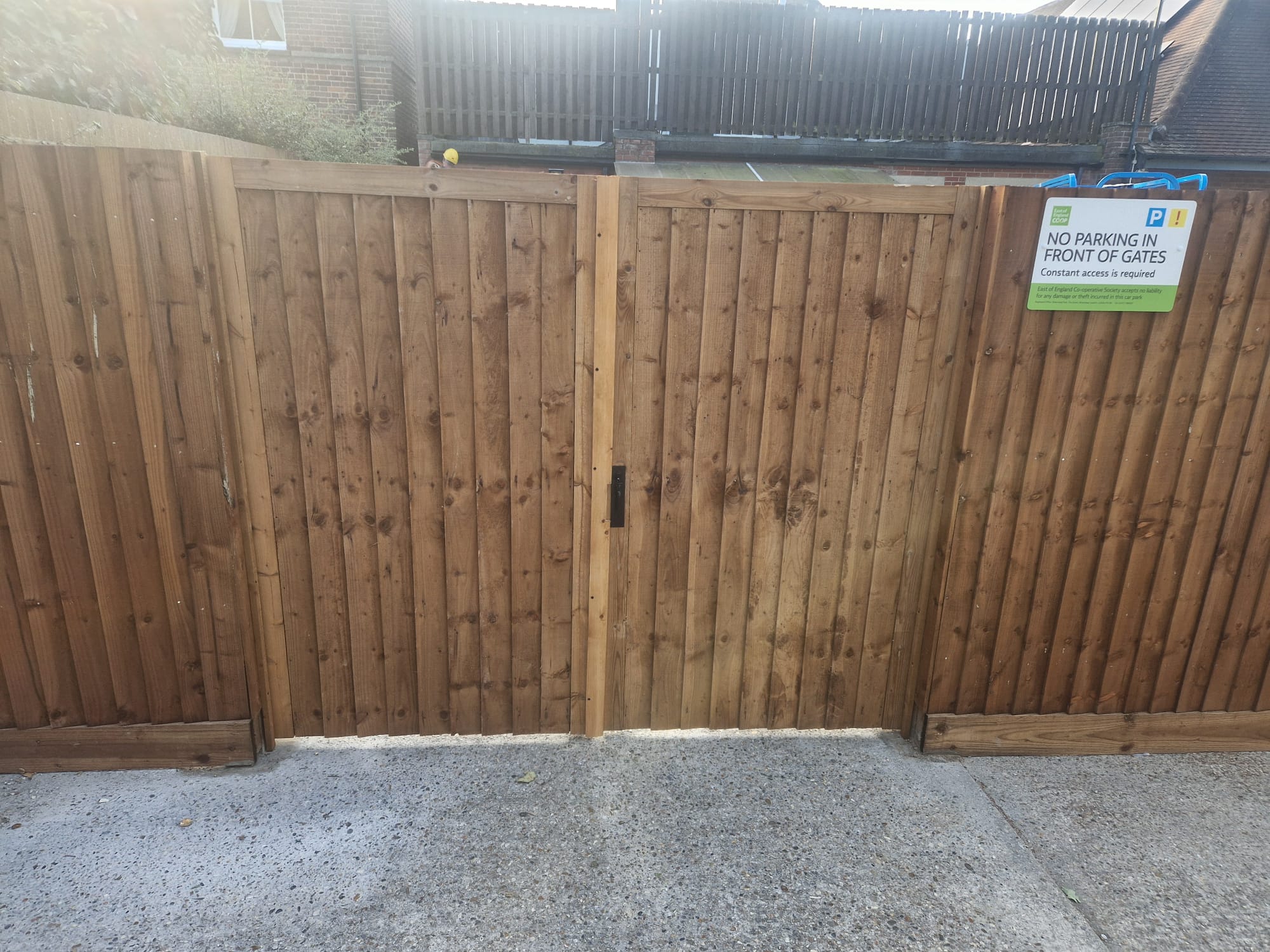 Close boarded timber double gate to a car park