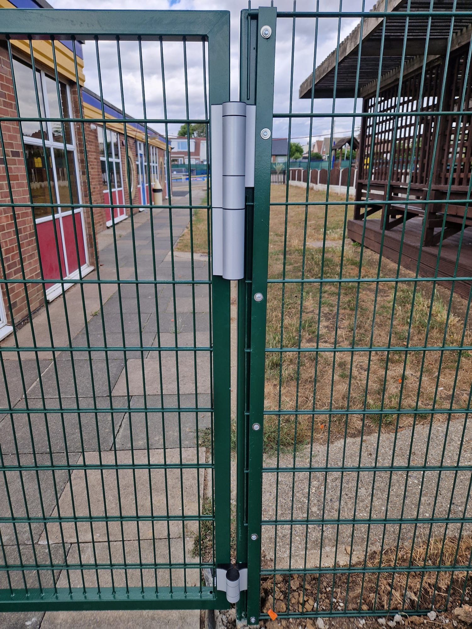 Close view of the green mesh gate hinge and post detail